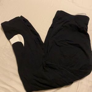 Black Nike cropped leggings with white logo. SizeL